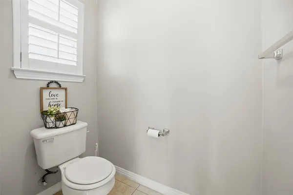 a white toilet sitting next to a bathroom sink