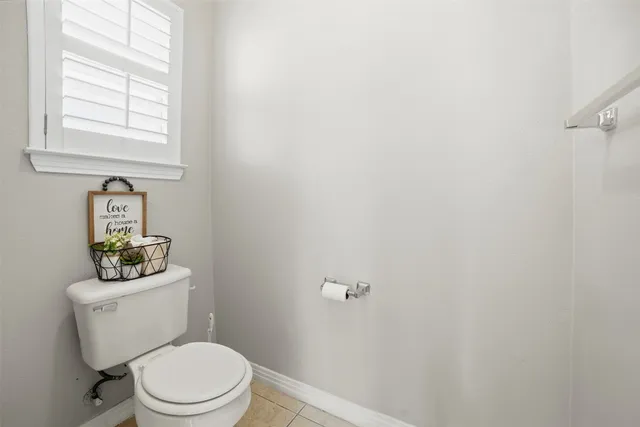 a white toilet sitting next to a bathroom sink