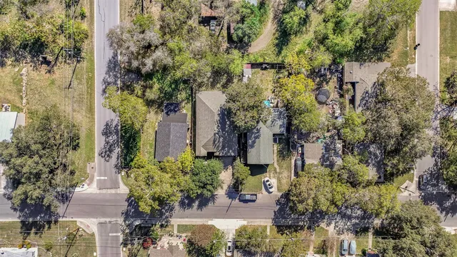 an aerial view of a house with a yard