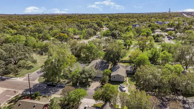 an aerial view of a house with a yard
