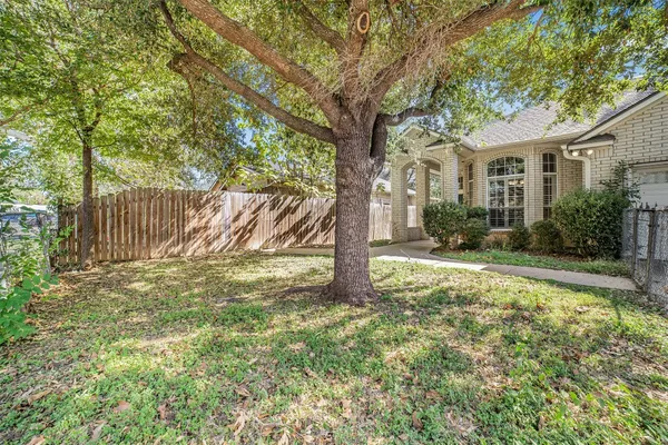 a view of a house with yard and a tree