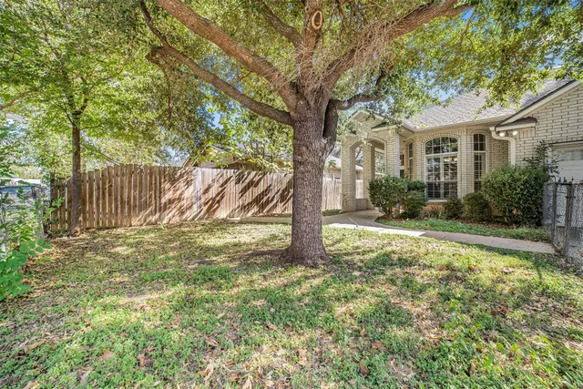 a view of a house with yard and a tree
