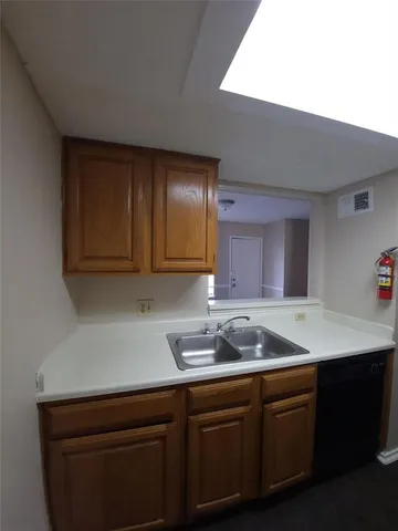 a kitchen with a sink cabinets and window