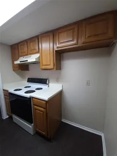 a kitchen with stainless steel appliances granite countertop a stove and a refrigerator