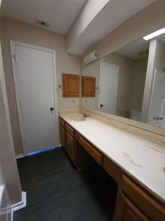 8005 Rothington Road, Unit 57 Dallas, TX 75227 - Photo 9 of 15 Bathroom with double vanity and toilet