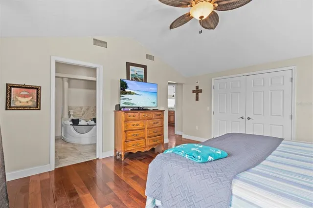 a spacious bathroom with a granite countertop double vanity sink and a mirror