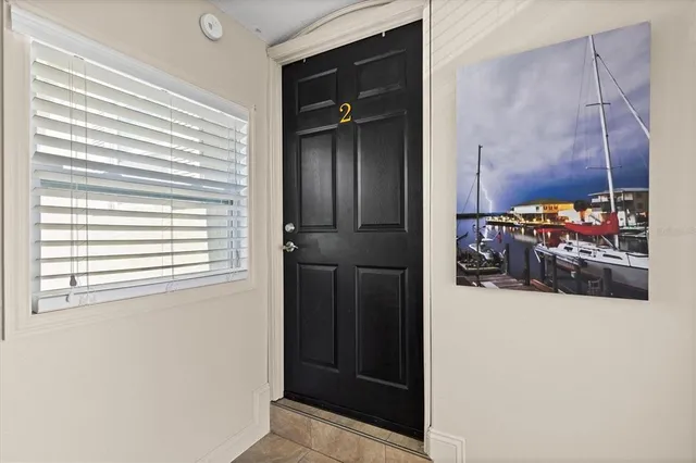 a bedroom with bed and wooden floor
