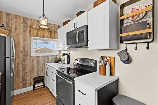 a view of a patio with a table and chairs and a barbeque