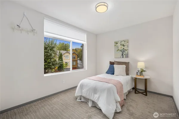 a bedroom with a bed and a window