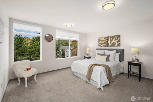 a bedroom with a bed and a large window