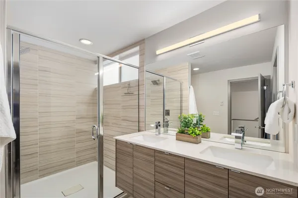 a bathroom with a double vanity sink and mirror