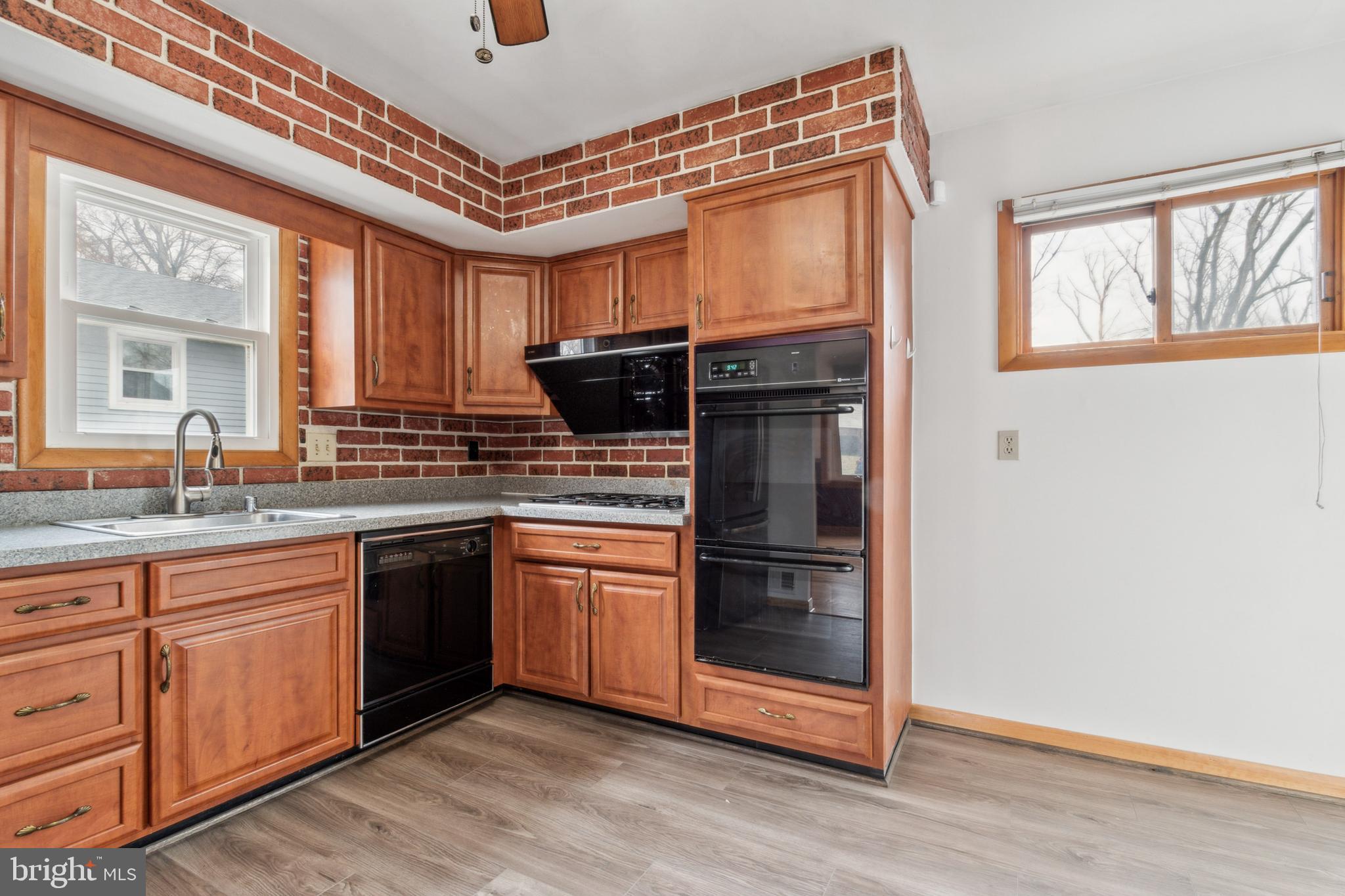 3308 Upton Road Baltimore, MD 21234 - Photo 11 of 44 a kitchen with stainless steel appliances granite countertop a stove a sink and a refrigerator