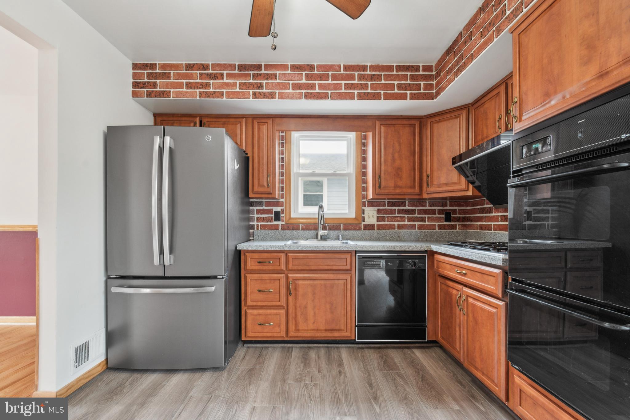 3308 Upton Road Baltimore, MD 21234 - Photo 13 of 44 a kitchen with granite countertop stainless steel appliances and wooden cabinets