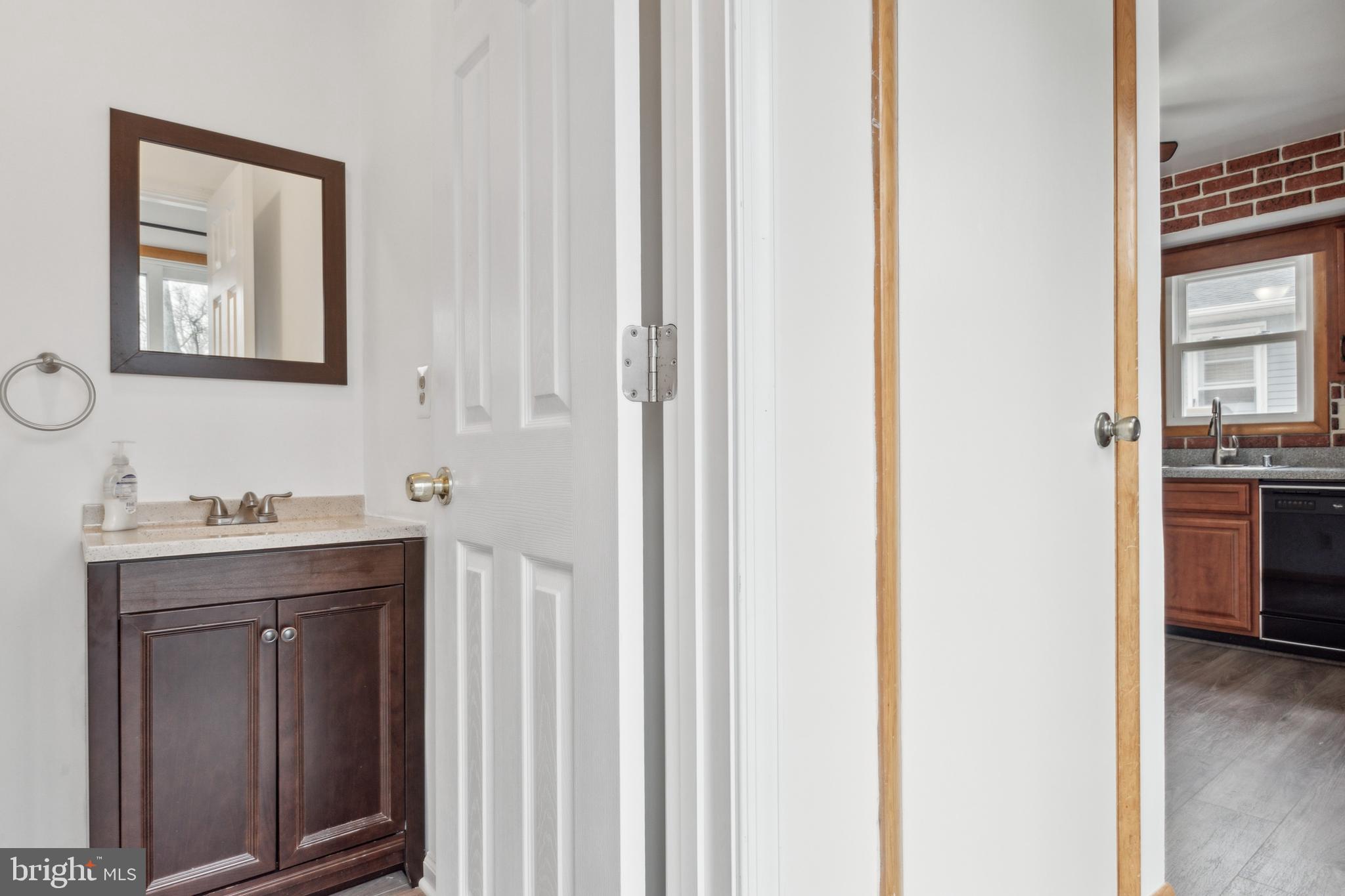 3308 Upton Road Baltimore, MD 21234 - Photo 14 of 44 a bathroom with a granite countertop sink and a mirror