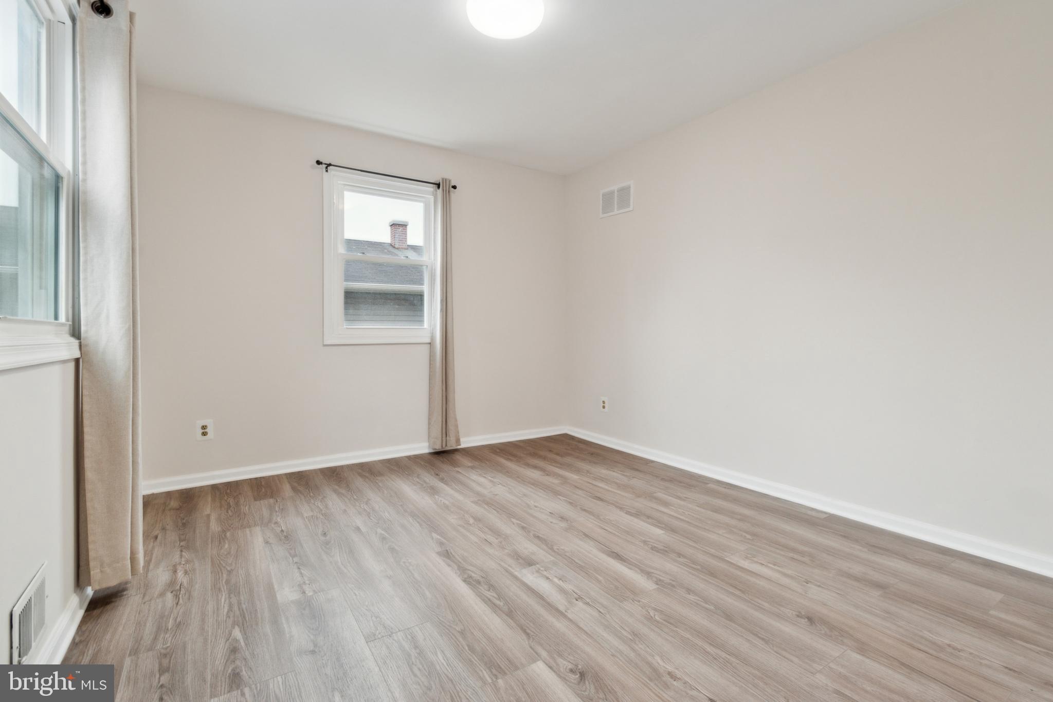 3308 Upton Road Baltimore, MD 21234 - Photo 15 of 44 an empty room with wooden floor and windows