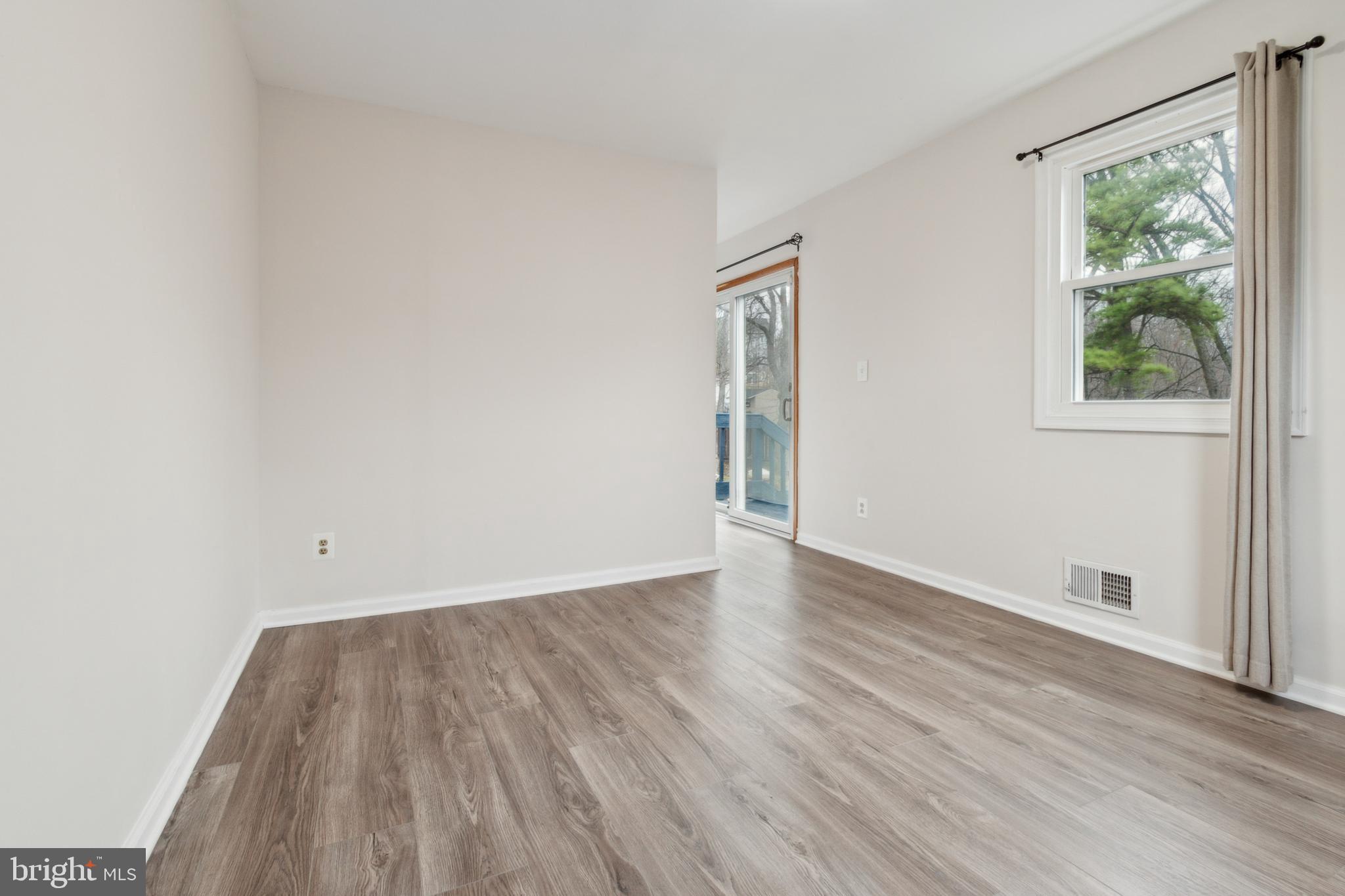 3308 Upton Road Baltimore, MD 21234 - Photo 17 of 44 an empty room with wooden floor and windows