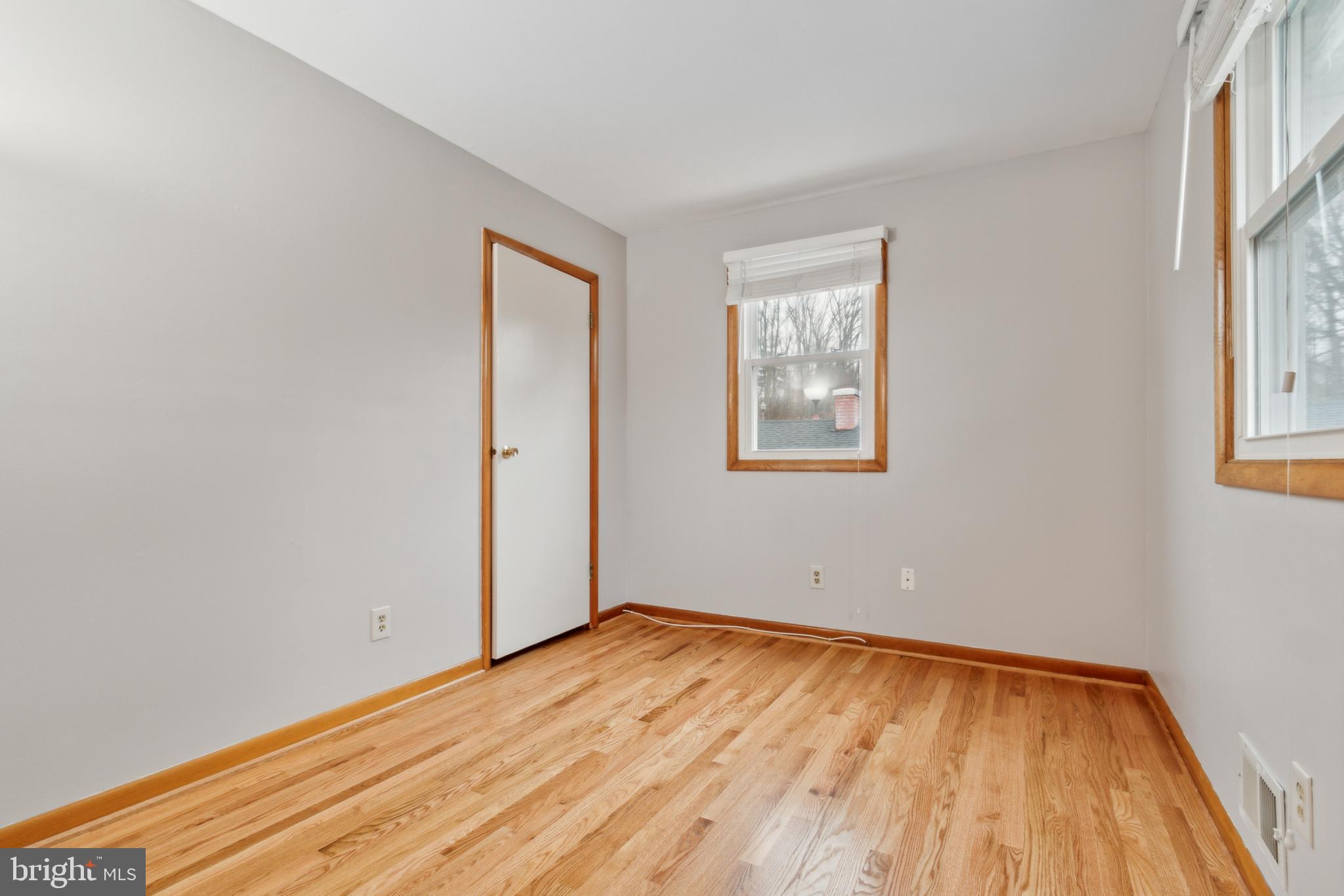3308 Upton Road Baltimore, MD 21234 - Photo 18 of 44 an empty room with wooden floor and windows