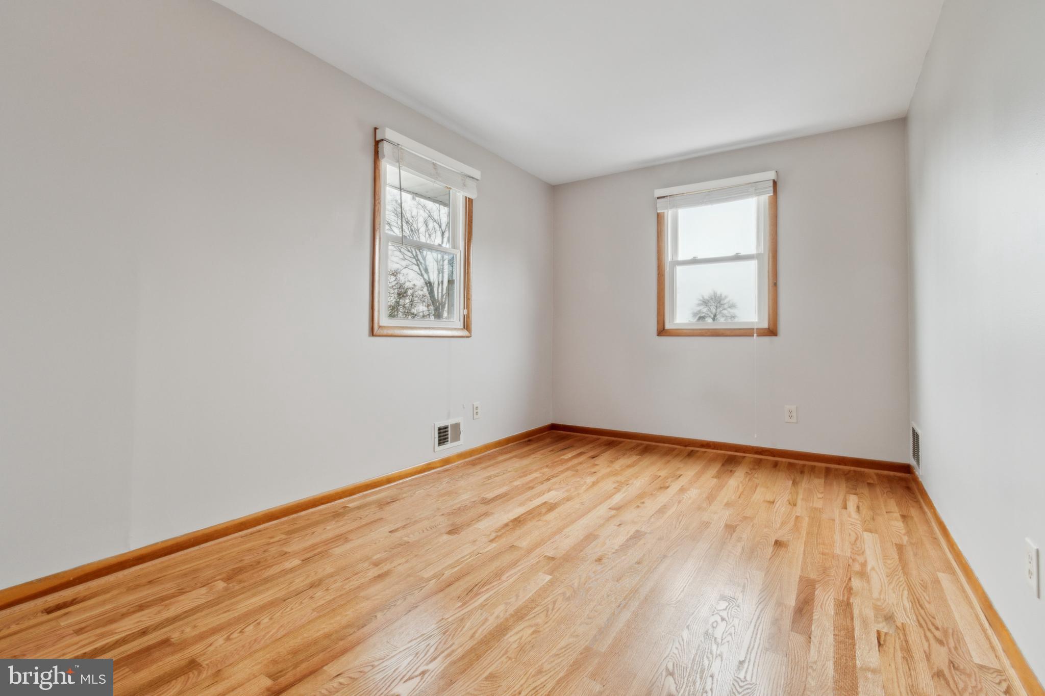 3308 Upton Road Baltimore, MD 21234 - Photo 19 of 44 a view of an empty room with wooden floor and a window