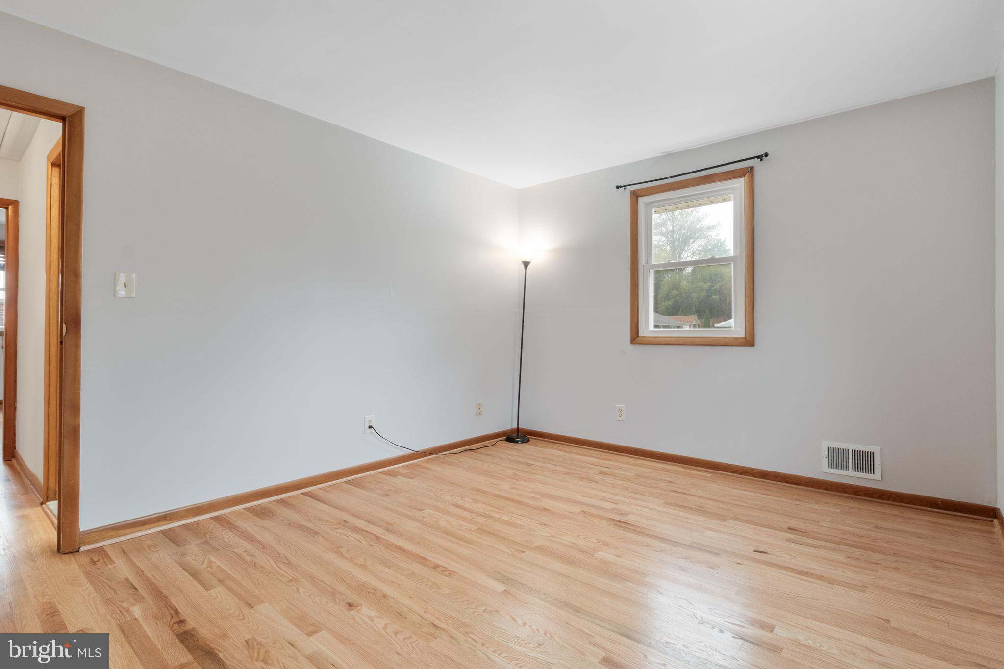 3308 Upton Road Baltimore, MD 21234 - Photo 30 of 44 a view of an empty room with wooden floor and a window