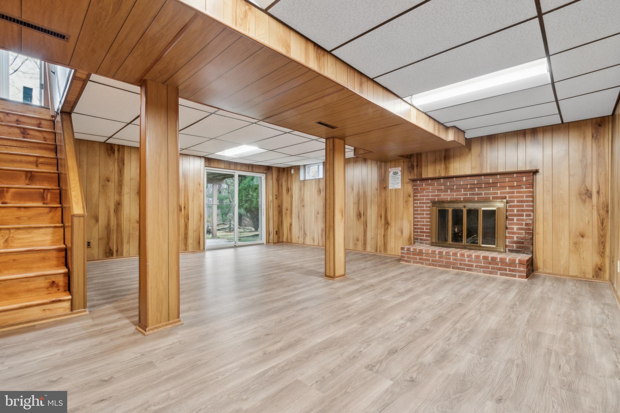 3308 Upton Road Baltimore, MD 21234 - Photo 31 of 44 a view of an empty room with wooden floor fireplace and a window