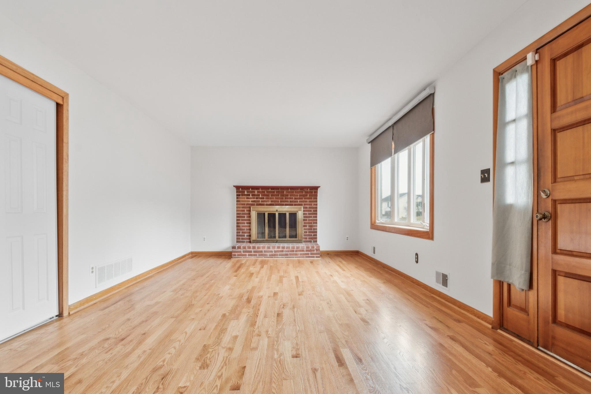 3308 Upton Road Baltimore, MD 21234 - Photo 5 of 44 a view of an empty room with a window and wooden floor