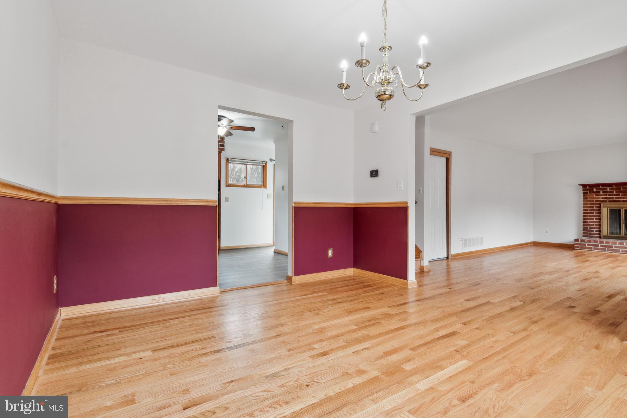 3308 Upton Road Baltimore, MD 21234 - Photo 9 of 44 a view of a hallway with wooden floor and a chandelier
