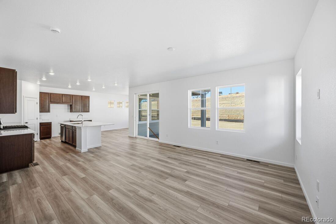 39803 Penn Road Elizabeth, CO 80107 - Photo 11 of 43 a view of kitchen with microwave a refrigerator and a stove top oven