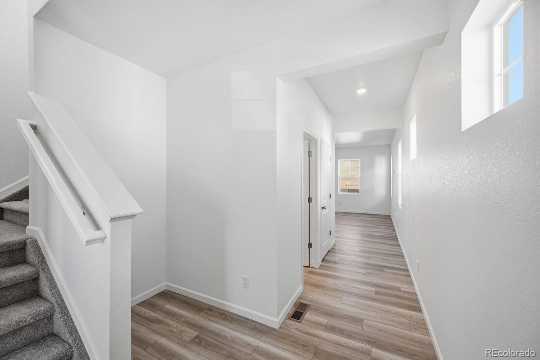 39803 Penn Road Elizabeth, CO 80107 - Photo 13 of 43 a view of a hallway with wooden floor and entryway