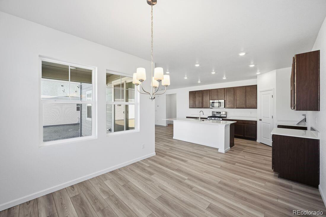 39803 Penn Road Elizabeth, CO 80107 - Photo 15 of 43 a view of kitchen with kitchen island white cabinets and stainless steel appliances
