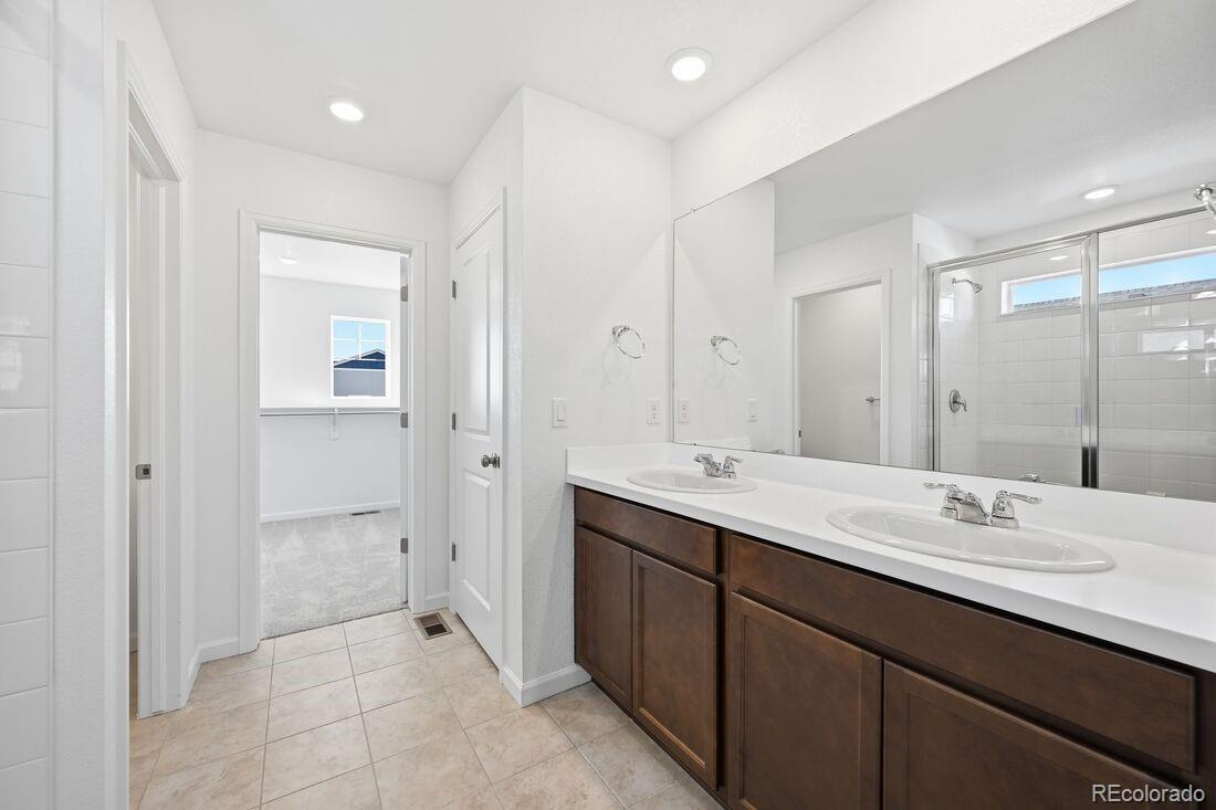 39803 Penn Road Elizabeth, CO 80107 - Photo 19 of 43 a bathroom with a double vanity sink mirror and shower