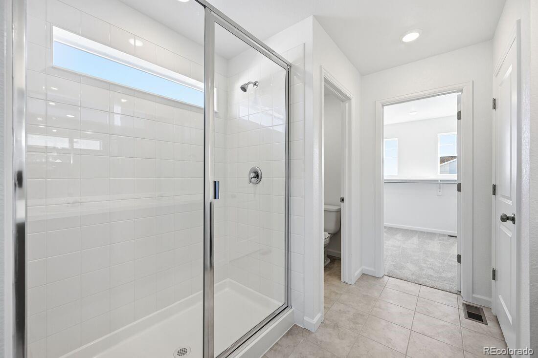 39803 Penn Road Elizabeth, CO 80107 - Photo 20 of 43 a bathroom with a shower and a glass door