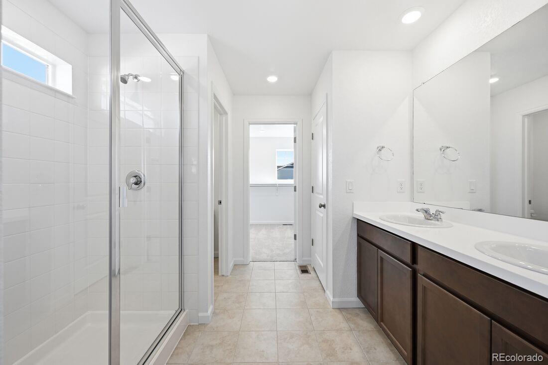 39803 Penn Road Elizabeth, CO 80107 - Photo 21 of 43 a spacious bathroom with a mirror sink and shower