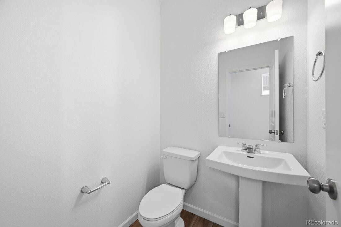 39803 Penn Road Elizabeth, CO 80107 - Photo 26 of 43 a bathroom with a sink a toilet and mirror