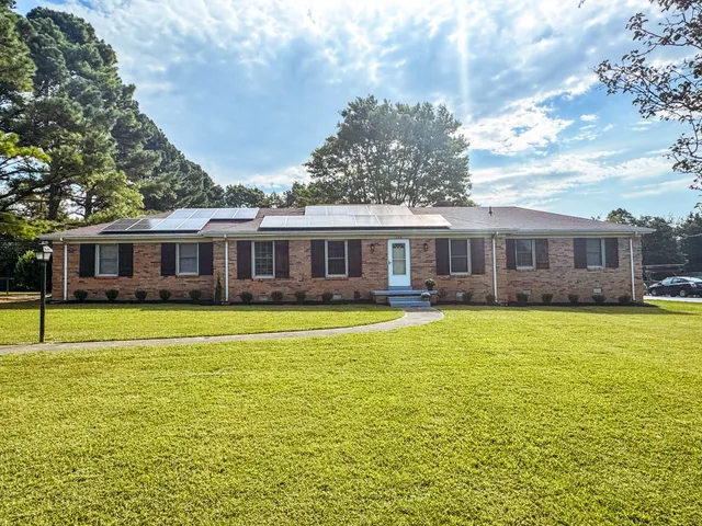 a front view of a house with swimming pool and porch