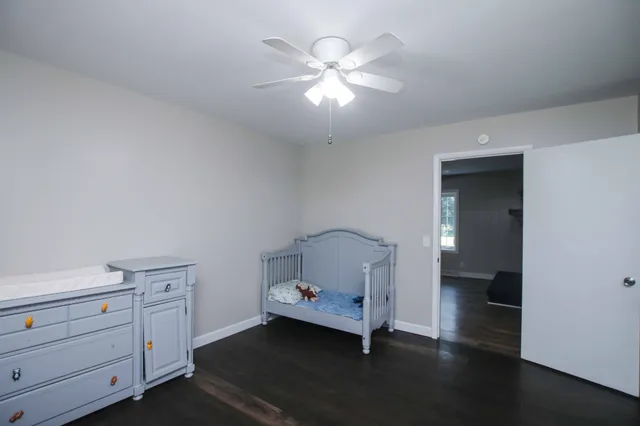 a room with a baby crib and a dresser