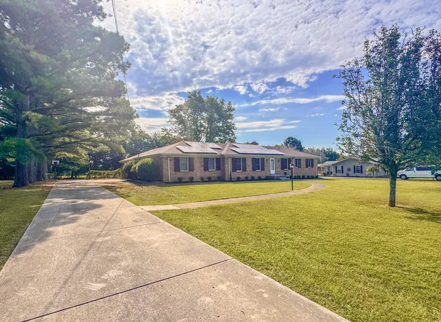 a swimming pool with outdoor seating and yard