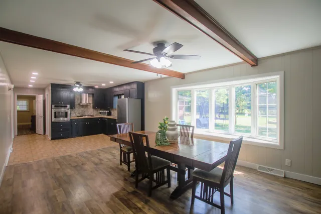 a view of a dining room with furniture window and wooden floor