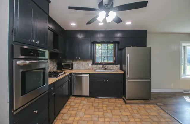 a kitchen with a refrigerator a sink and dishwasher