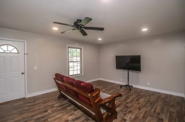 a living room with furniture and a flat screen tv