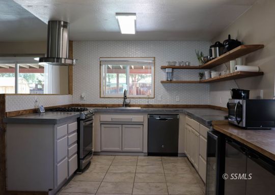 205 Kimberly Lane Ridgecrest, CA 93555 - Photo 8 of 39 a kitchen with stainless steel appliances granite countertop a sink and stove