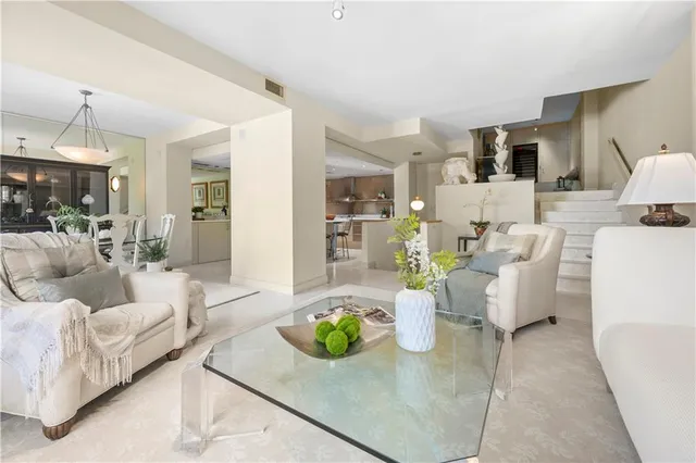 a living room with furniture and a chandelier
