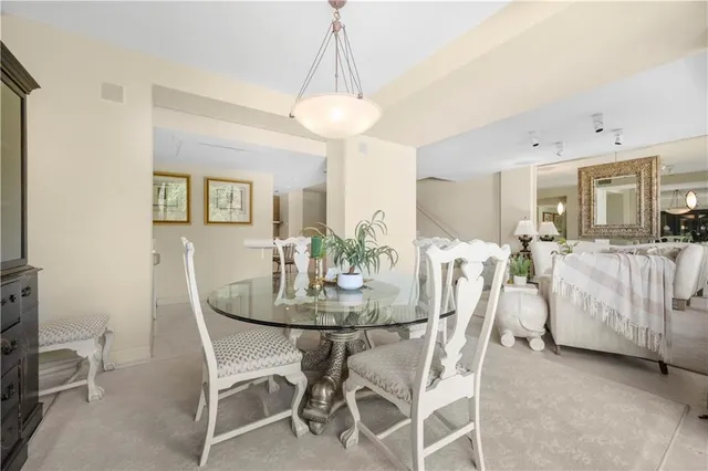 a view of a dining room with furniture and a chandelier
