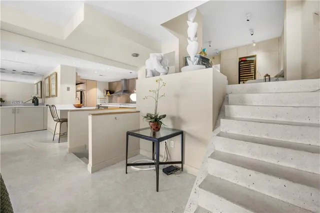 a living room with furniture and kitchen view
