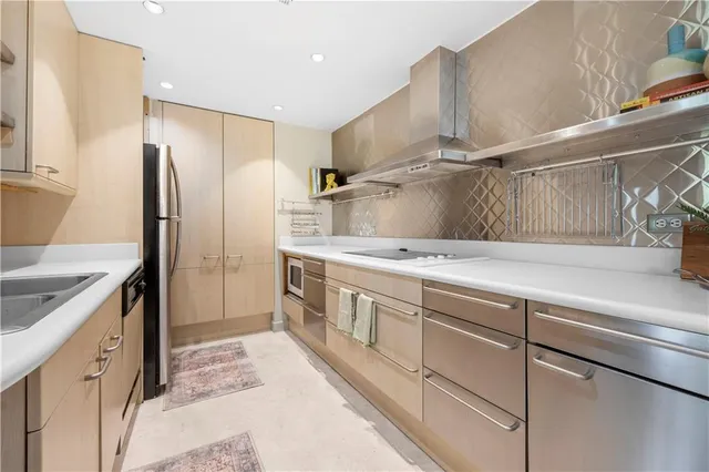 a large kitchen with a sink and cabinets