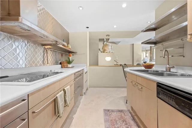 a kitchen with granite countertop a sink stove and refrigerator