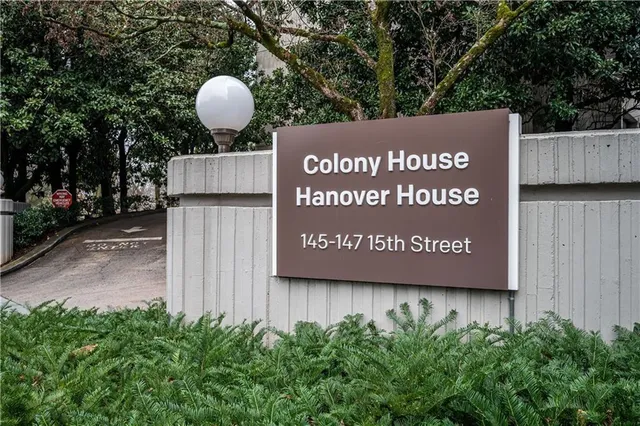 a view of outdoor space with sign board and wooden fence