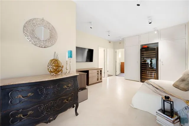 a bedroom with a bed and windows