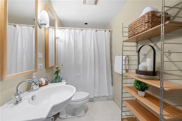 a bathroom with a sink toilet and shower