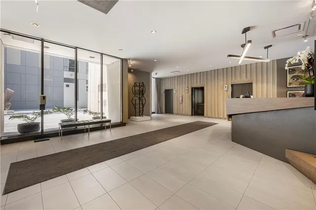 a view of a spacious bedroom with a large window