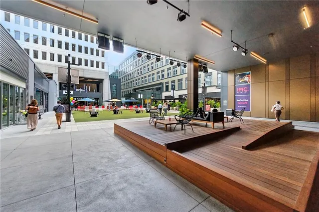 a living room with furniture pool table and a large window